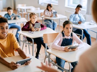 Multiracial Group Of School Kids Using Touchpads And Listening To Picture Id1390581508 Blue Filter